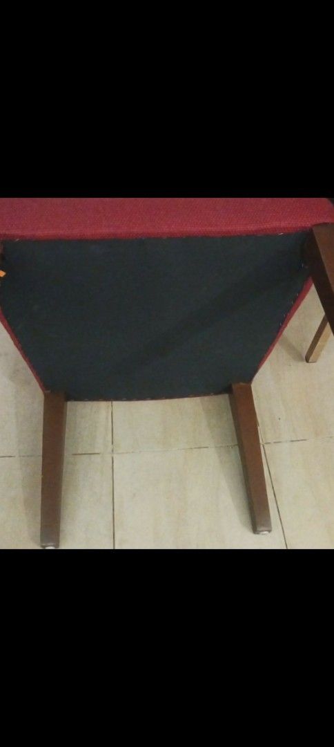 Red Upholstered Armchair with Cutout Back (Category: Chairs) located in Las Pinas. Submitted by jesus1smysavi0r (Listing ID 1464359471, Image 3). Description: - Comfortable armchair with a unique backrest cutout. - Upholstered in a textured red fabric. - Sturdy wooden legs. - Perfect for adding a vibrant accent to any room..