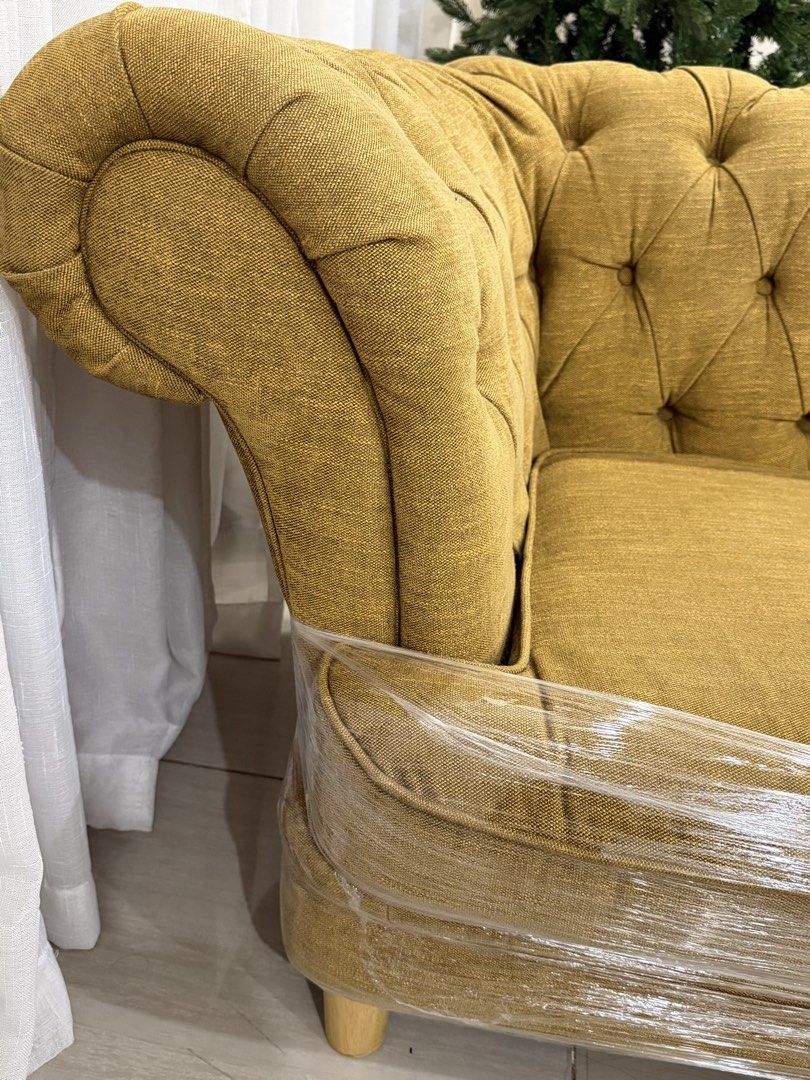 Relax Form Tufted Chesterfield Sofa with 2 Ottomans (Category: Sofas) located in Pakil. Submitted by abeverage (Listing ID 1464466598, Image 3). Description: - Relax Form Chesterfield Sofa Set - Includes two matching square ottomans - Deep button tufting and elegant rolled arms - Upholstered in a textured mustard yellow fabric - Sofa is wrapped in protective plastic - Ideal for living rooms or lounge areas.