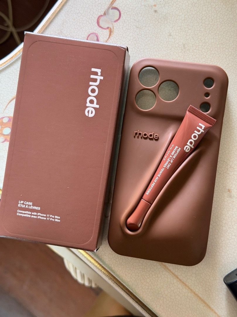 Rhode Lip Case with Peptide (Authentic) (Category: Cases & Sleeves) located in Manila. Submitted by kleove (Listing ID 1464373060, Image 1). Description: - Rhode Lip Case for iPhone 17 Pro Max - Color: Bronze - Includes Rhode Peptide Lip Tint (Honey Mango) - All items are from Rhode.