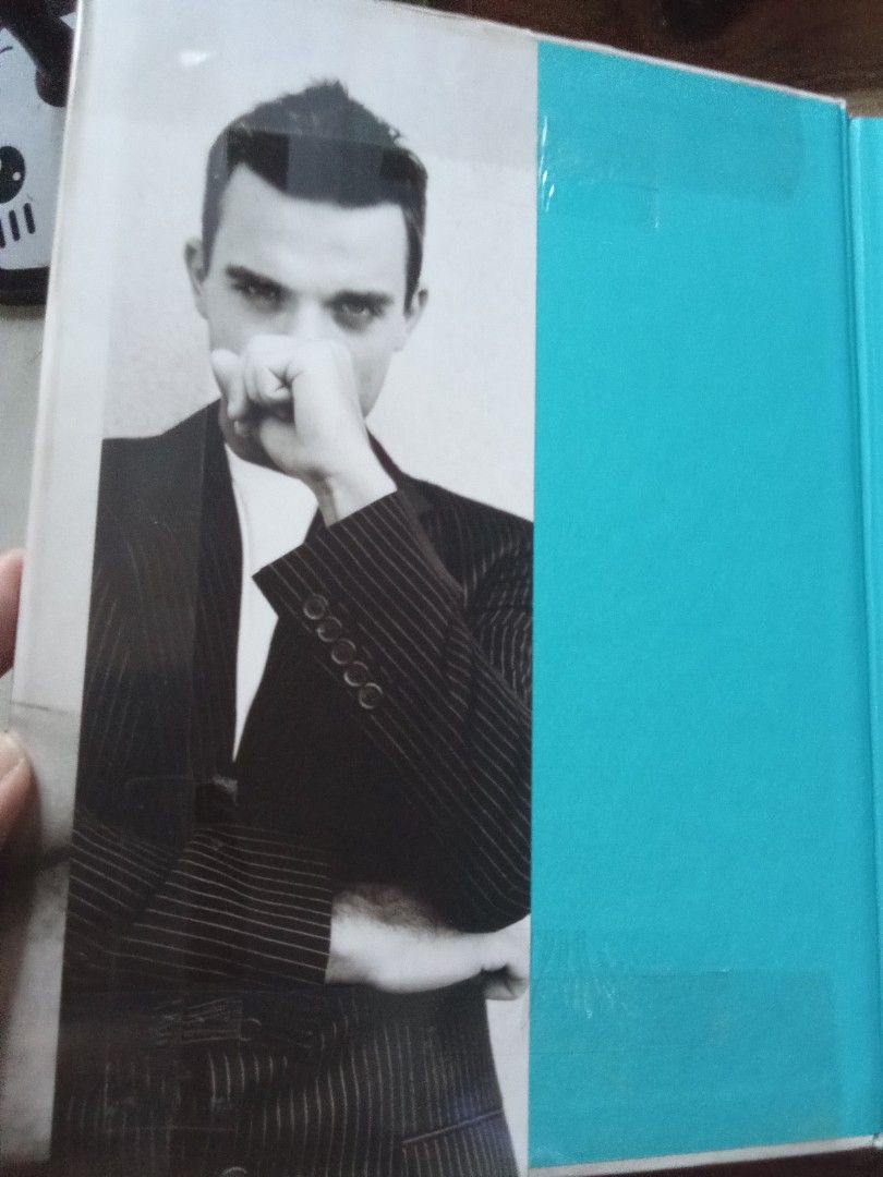 Robbie Williams autobiography hardcover book (Category: Storybooks) located in Pasig City. Submitted by teebeedeee (Listing ID 1464569470, Image 2). Description: preowned hardcover book complete full colored glossy pages plastic covered.no visible penmarks.visible sticker mark sa back cover for meetups in pasig rotonda or jnt shipping or lalamove grab payment via gcash or lalamove grab or unionbank .