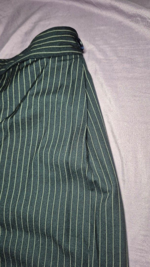 ROCOCO Pinstripe Wrap Midi Skirt with Pockets (Category: Jeans) located in Manila. Submitted by liv31_ (Listing ID 1464472949, Image 2). Description: ROCOCO Pinstripe Wrap Midi Skirt with Pockets ​Has discreet, deep side pockets. ​ Classic fine vertical pinstripes on dark charcoal/forest-tone fabric, contrasted with a smooth solid blue/slate underlay. ​ Ideal for workwear, smart casual, or academia-inspired styling. .