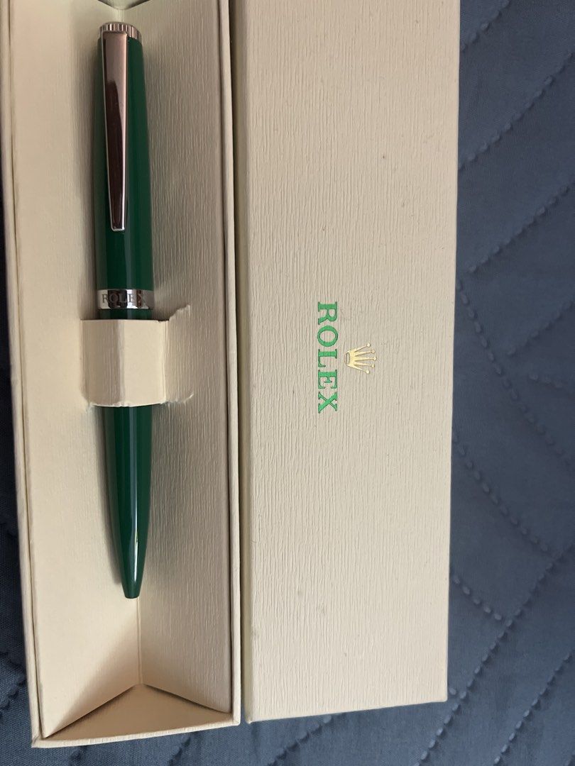 Rolex Collectable Green Pen. (Category: Stationery & School Supplies) located in Quezon City. Submitted by lucky876 (Listing ID 1464456132, Image 1). Description: - Elegant green pen - Features a silver band with 'ROLEX' engraving - Smooth writing instrument - Comes in original packaging.