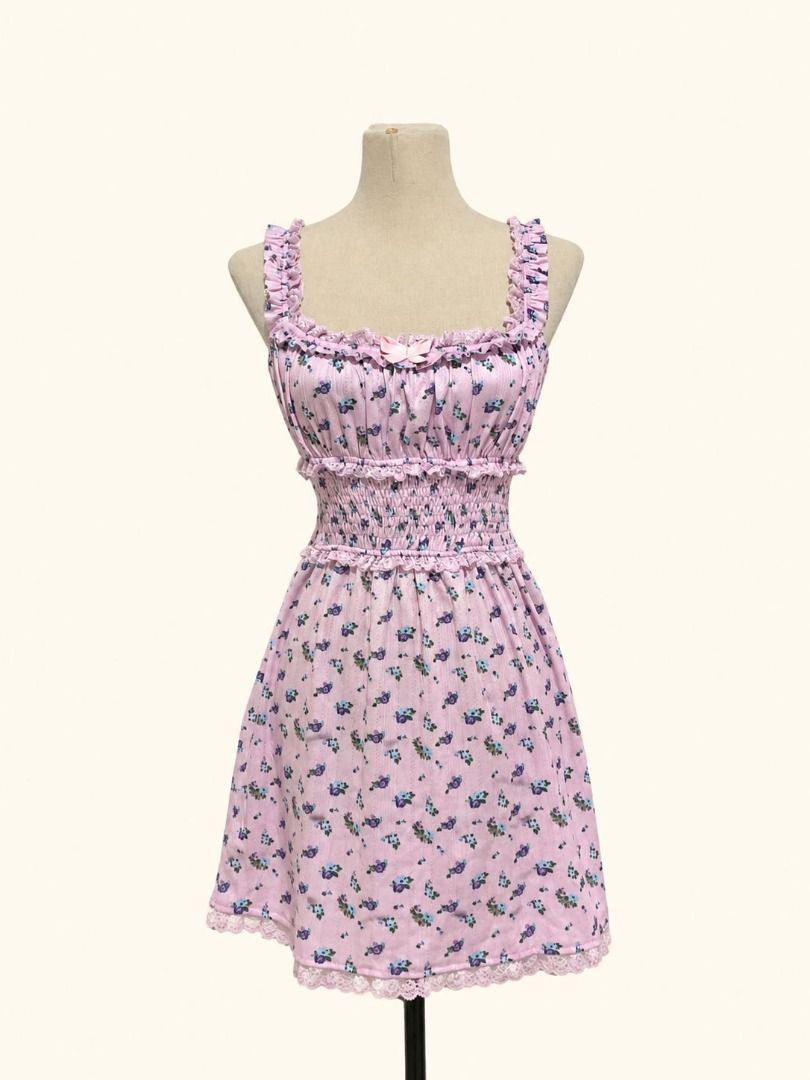 Rosie Bloom Mini Dress (Category: Dresses) located in Angeles City. Submitted by thebeehivecloset (Listing ID 1464488824, Image 1). Description: A cute and feminine floral mini dress featuring a smocked bodice, delicate ruffle details, lace accents, and a sweet bow for a soft vintage-inspired look.