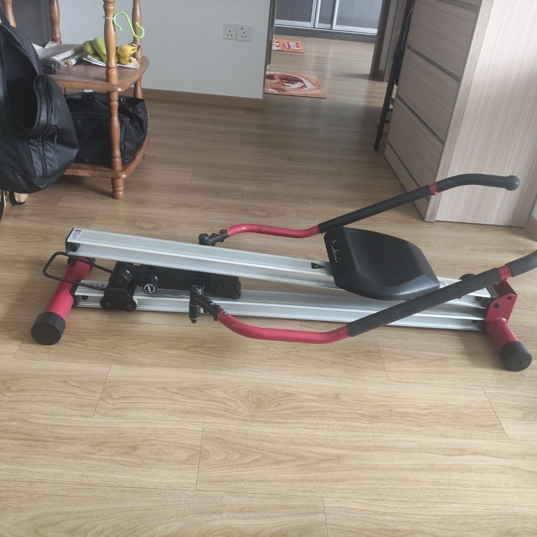 Rowing Machine (Category: Cardio & Fitness Machines) located in Singapore. Submitted by hurricanethree (Listing ID 1464486965, Image 2). Description: - Silver rowing machine with red accents - Black seat and handles - Folds for convenient storage - Ideal for full-body home workouts - Ready for a new owner.