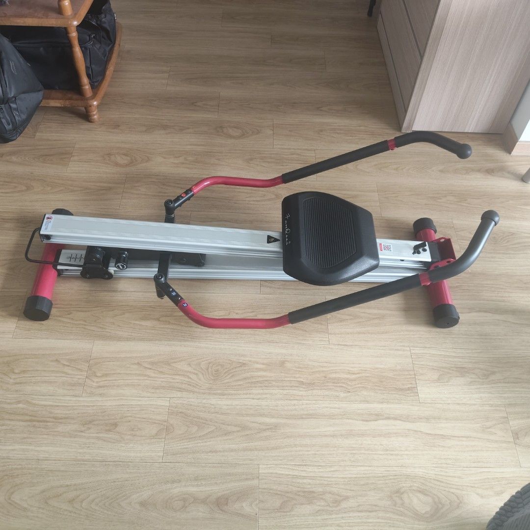 Rowing Machine (Category: Cardio & Fitness Machines) located in Singapore. Submitted by hurricanethree (Listing ID 1464486965, Image 1). Description: - Silver rowing machine with red accents - Black seat and handles - Folds for convenient storage - Ideal for full-body home workouts - Ready for a new owner.