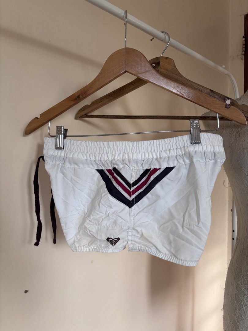 Roxy White Athletic Shorts with Stripes (Category: Shorts) located in Manila. Submitted by galitsabarat (Listing ID 1464516272, Image 3). Description: - White Roxy athletic shorts - Elastic waistband with adjustable drawstring - Stylish striped details on the sides - Flattering V-shape detail on the back - Small, iconic Roxy logo at the bottom back - Versatile for sports activities or everyday casual wear.