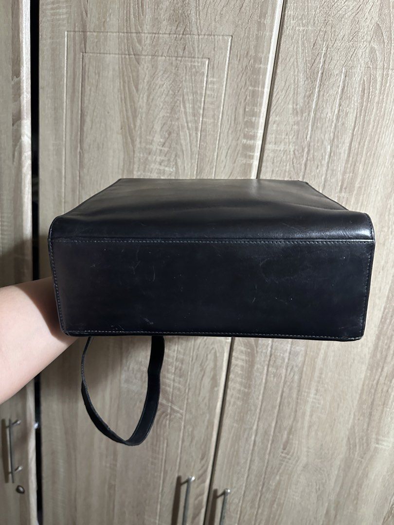 Salvatore Ferragamo Black Leather Top Handle Bag (Category: Luxury Bags & Wallets) located in Makati City. Submitted by love003xx (Listing ID 1463660709, Image 3). Description: - Classic black leather handbag by Salvatore Ferragamo - Features iconic ribbon detail with gold accent - Interior zip pocket for organization - Detachable strap for shoulder or crossbody wear - Made in Italy - Versatile for everyday use or special occasions.