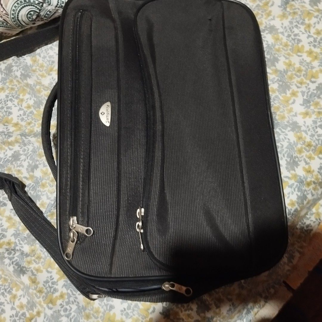 Samsonite Black Briefcase Laptop Bag (Category: Briefcases) located in Manila. Submitted by lene48 (Listing ID 1464393872, Image 2). Description: - Samsonite black briefcase - Multiple zippered compartments for organization - Padded handle, 16 x 12 inches - Detachable shoulder strap - Durable material - Smooth working zippers - Ideal for work or travel.