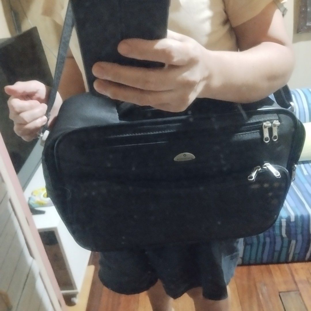 Samsonite Black Briefcase Laptop Bag (Category: Briefcases) located in Manila. Submitted by lene48 (Listing ID 1464393872, Image 3). Description: - Samsonite black briefcase - Multiple zippered compartments for organization - Padded handle, 16 x 12 inches - Detachable shoulder strap - Durable material - Smooth working zippers - Ideal for work or travel.