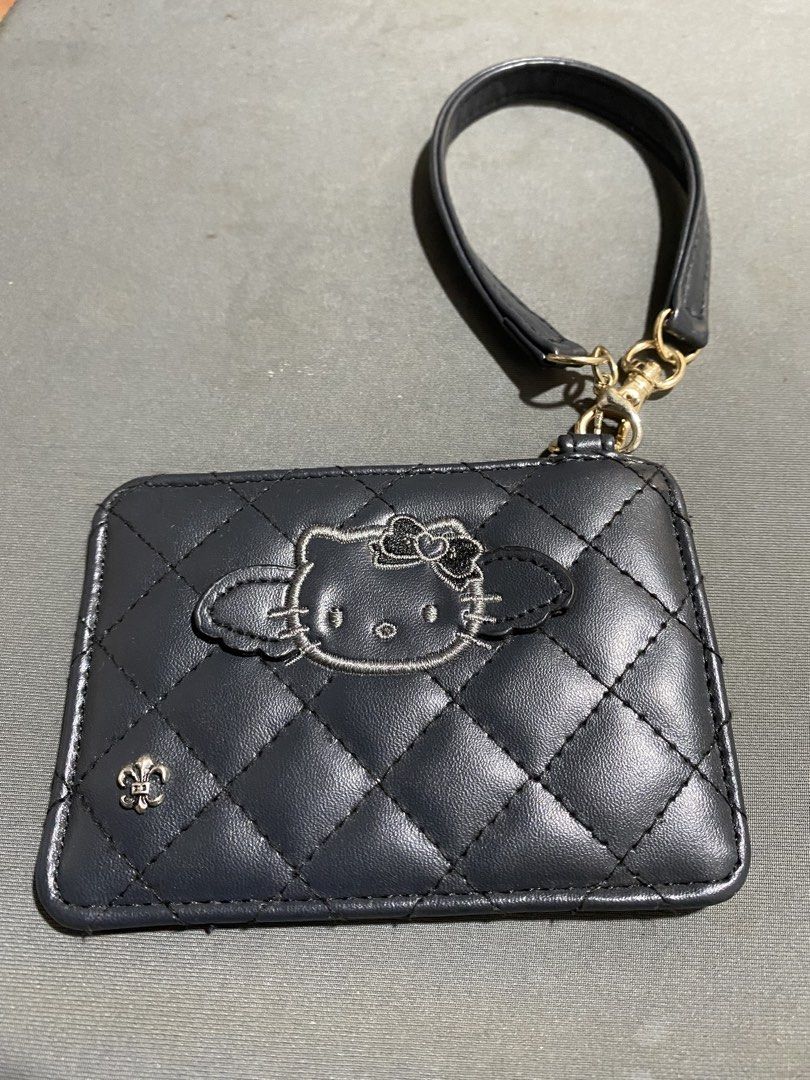 Sanrio Black Quilted Hello Kitty Card Holder with Strap (Category: Wallets & Card holders) located in San Juan City. Submitted by fastturtle_d9ad50 (Listing ID 1464360366, Image 1). Description: Sanrio Black Quilted Hello Kitty Card Holder with Strap - Black quilted card holder - Clear window for ID or cards - Detachable wrist strap included.
