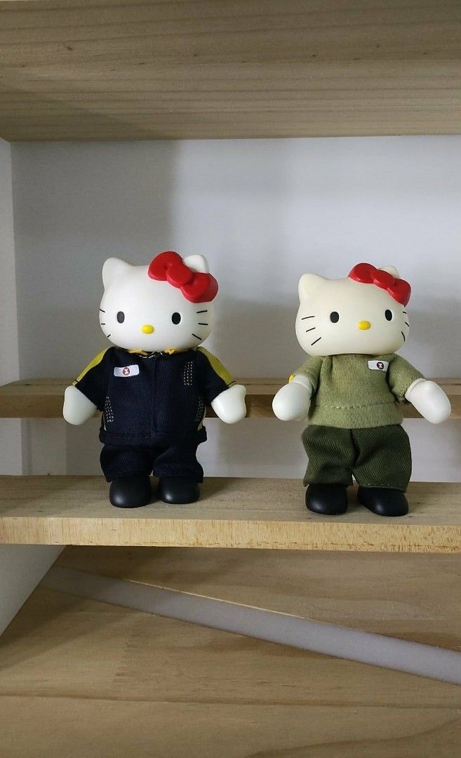 Set of 2 Hello Kitty Figures in Uniforms (Category: Figurines & Statues) located in Caloocan City. Submitted by jark_moonshop (Listing ID 1464356717, Image 1). Description: take all 2 for 399 pesos or 250 pesos each. - Set of 2 adorable Kitty figures. - One figure wears a dark blue and yellow uniform. - The other figure is dressed in a cute green uniform. - Both figures feature their signature red bows. - Displayed on a charming wooden shelf. - I