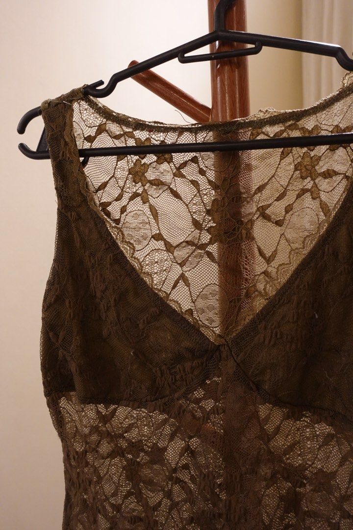 Sheer Lace V-Neck Sleeveless Top (Category: Sleeveless) located in Pasig City. Submitted by hulyascloset (Listing ID 1464544647, Image 2). Description: - Olive green lace top - V-neckline - Sleeveless design - All-over floral lace pattern - Slightly scalloped hemline - Ideal for layering over bralettes or camisoles - Features nice texture and detail.