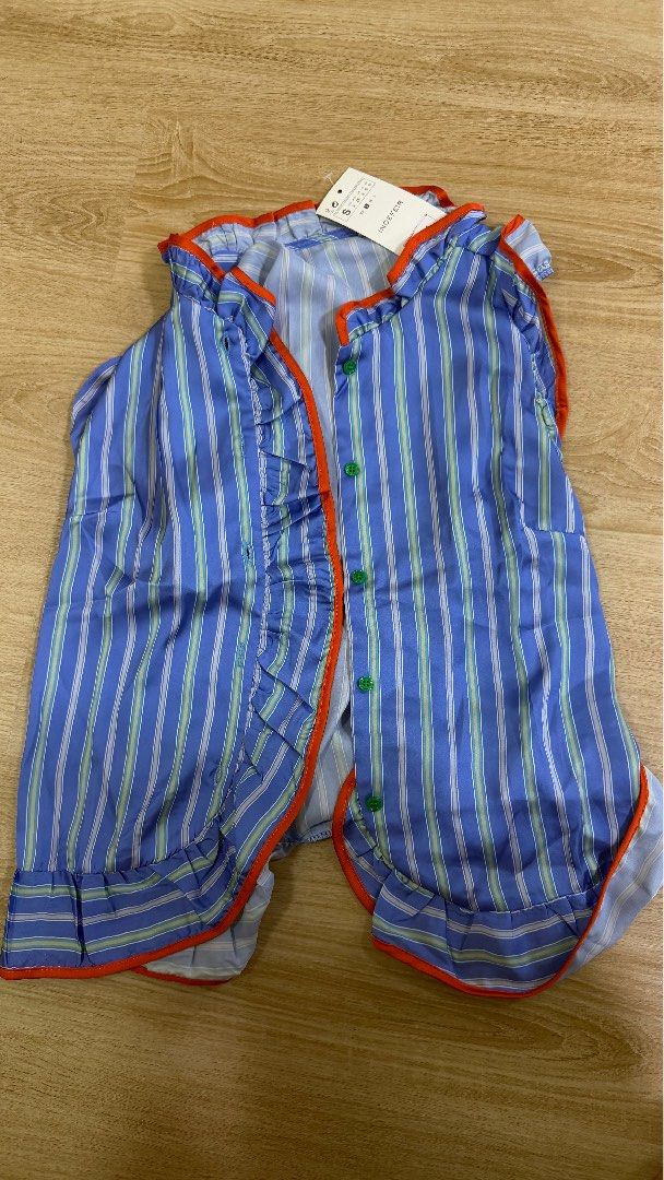 Shein Blue Striped Ruffle Sleeveless Blouse (Category: Sleeveless) located in Taguig. Submitted by beanutputter00 (Listing ID 1464405613, Image 3). Description: - INDEFIR blue striped sleeveless blouse - Features orange trim and ruffles on neckline, front, and hem - Button-up front - Versatile for pairing with shorts or jeans - Ideal for casual outings tags zara mango shein.