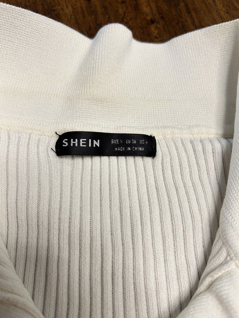 SHEIN White V-Neck Knit Top (Category: Shirts) located in Antipolo. Submitted by tshopph (Listing ID 1464476998, Image 3). Description: Shein White Ribbed Collar Knit Top A chic, preppy basic that pairs effortlessly with high-waisted trousers, skirts, or jeans. Features a soft ribbed knit material with a classic open polo collar for an elevated, clean look. ✨ Style: Open Polo Collar / V-Neckline / Short Sleeve / Ribbed Knit ✨ Material: Ribbed Kni