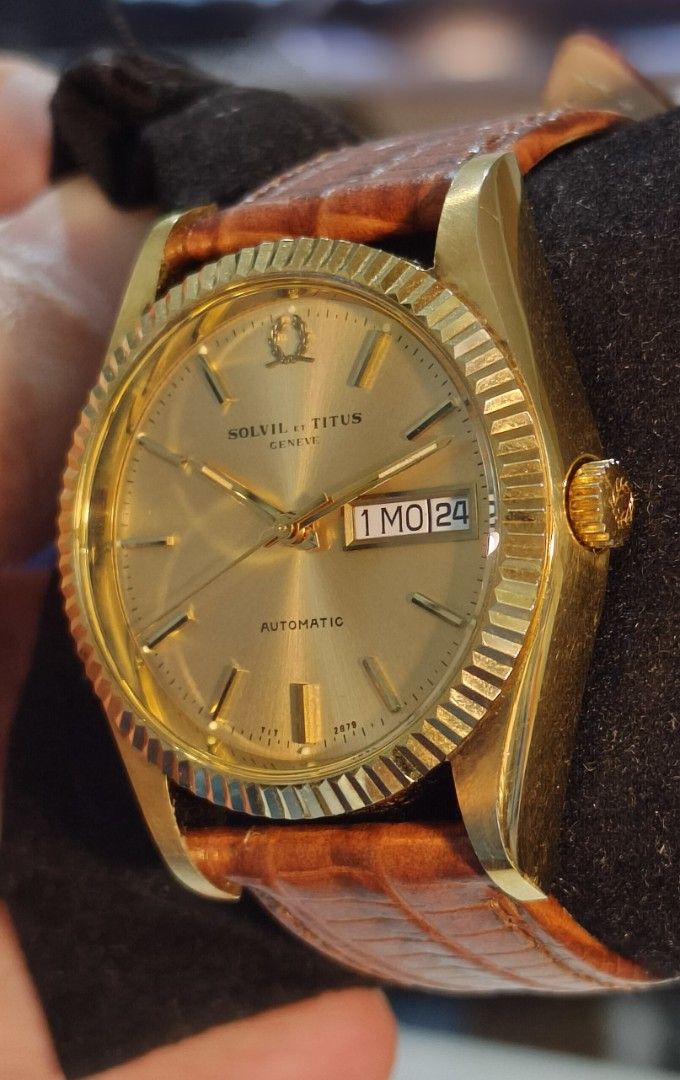 Solvil et Titus Geneve Automatic Day Date (Category: Men's Watches) located in Quezon City. Submitted by jtgabs (Listing ID 1464441390, Image 2). Description: - Vintage Solvil et Titus Geneve automatic watch - mid 1970s made: last of the brand's automatic movement - Gold tone case and dial - Day and date complication - Watch is running - Comes with a replacement brown leather strap - also comes with original gold tone metal bracelet - Some signs 