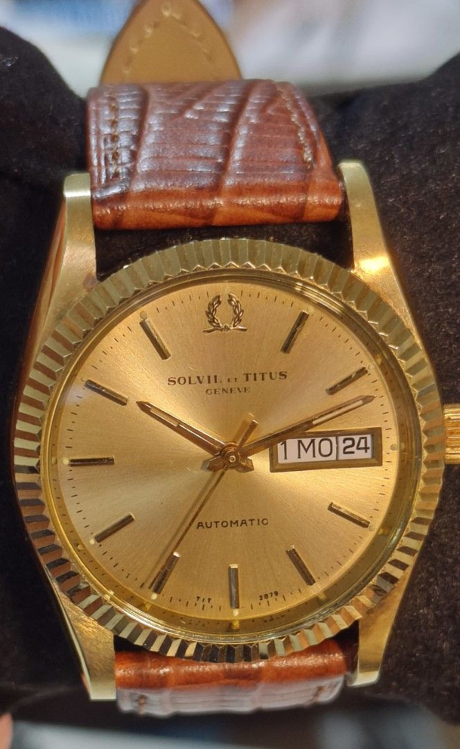Solvil et Titus Geneve Automatic Day Date (Category: Men's Watches) located in Quezon City. Submitted by jtgabs (Listing ID 1464441390, Image 1). Description: - Vintage Solvil et Titus Geneve automatic watch - mid 1970s made: last of the brand's automatic movement - Gold tone case and dial - Day and date complication - Watch is running - Comes with a replacement brown leather strap - also comes with original gold tone metal bracelet - Some signs 