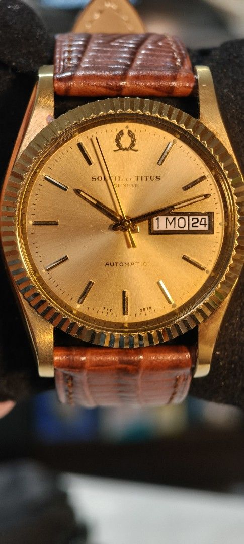 Solvil et Titus Geneve Automatic Day Date (Category: Men's Watches) located in Quezon City. Submitted by jtgabs (Listing ID 1464441390, Image 3). Description: - Vintage Solvil et Titus Geneve automatic watch - mid 1970s made: last of the brand's automatic movement - Gold tone case and dial - Day and date complication - Watch is running - Comes with a replacement brown leather strap - also comes with original gold tone metal bracelet - Some signs 