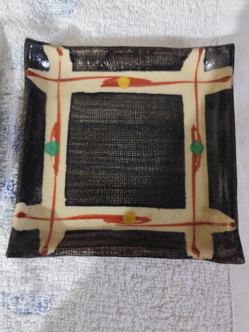 Square ceramic dish with abstract design (Category: Dinnerware & Cutlery) located in Manila. Submitted by marriage031073advocate (Listing ID 1464421124, Image 1). Description: - Unique square ceramic dish - Dark textured center - Cream border with red and yellow accents - Green and red dots on the sides - Abstract pattern - Ideal for trinkets or as a decorative piece.