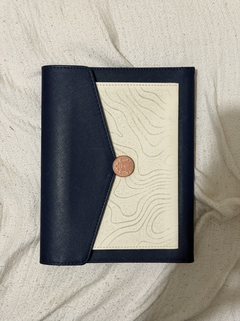 Starbucks Journal Pouch (Category: Stationery & School Supplies) located in Quezon City. Submitted by allthingspreloved.ph (Listing ID 1464556685, Image 1). Description: - Stylish navy blue wallet - Cream panel with unique topographic line design - Secure rose gold button closure - Interior card slots and pocket for easy organization - Perfect for keeping your journal and other items.