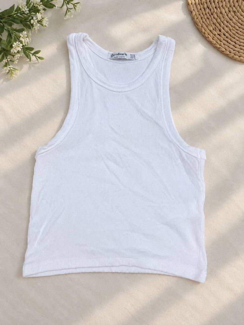 Stradivarius White Ribbed Tank Top (Category: Sleeveless) located in Manila. Submitted by dizonnixni94357 (Listing ID 1464397441, Image 1). Description: - Brand: Stradivarius - Color: White - Style: Ribbed tank top - Features: Sleeveless, racerback cut - Versatility: Great for everyday wear, pairs easily with jeans or skirts - Essential: A must-have wardrobe staple.