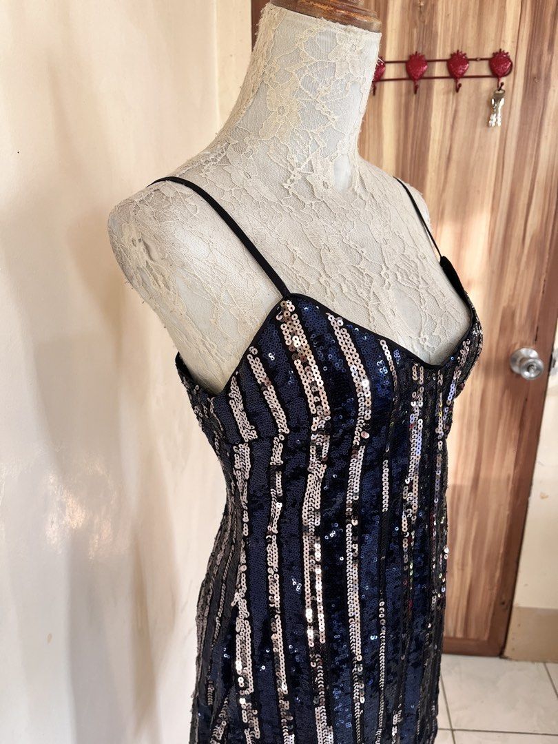Striped sequin cami mini dress (Category: Dresses) located in San Jose. Submitted by thymies (Listing ID 1464516918, Image 2). Description: Pattern & Fabric: Alternating vertical stripes of dark navy/black sequins and gold sequins set over a sheer mesh base. Silhouette & Length: Short, bodycon to slight A-line silhouette ending above the knee. Neckline & Straps: Gentle V-neckline with adjustable dark cami/spaghetti straps. Closure: Hidden back zi