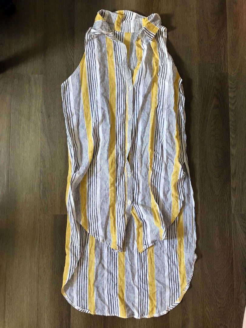 Striped Sleeveless Shirt with Collar (Category: Sleeveless) located in Manila. Submitted by joshbelgic17602 (Listing ID 1464437979, Image 1). Description: - Sleeveless collared shirt - Vertical stripe pattern (yellow, white, dark blue) - Button-up front - Curved hemline, longer at the back - Lightweight material, ideal for warm weather.