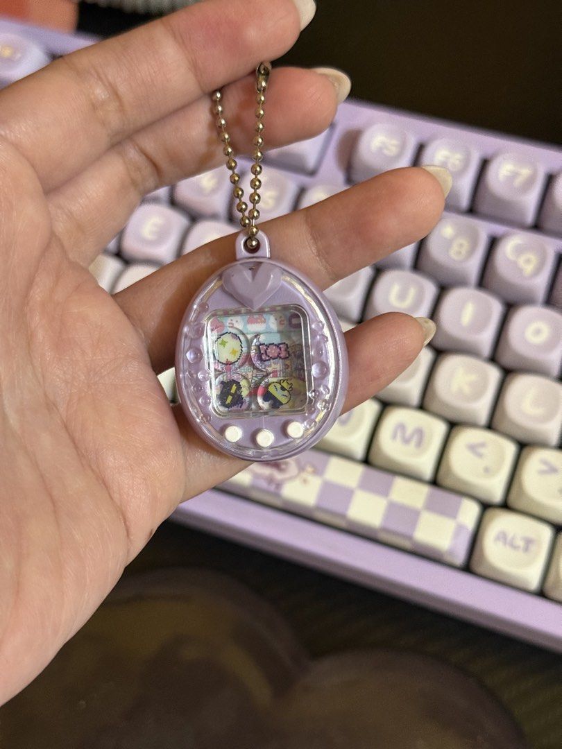 Tamagotchi Shaker Charms (Category: Designer & Blind Box Toys) located in Cabuyao City. Submitted by nethcantalejo8888 (Listing ID 1464567351, Image 1). Description: Tamagotchi Shaker Charm Purple Ps - Brand new, 1st and 2nd pic for reference only J&T shipping or SDD in nearby areas..