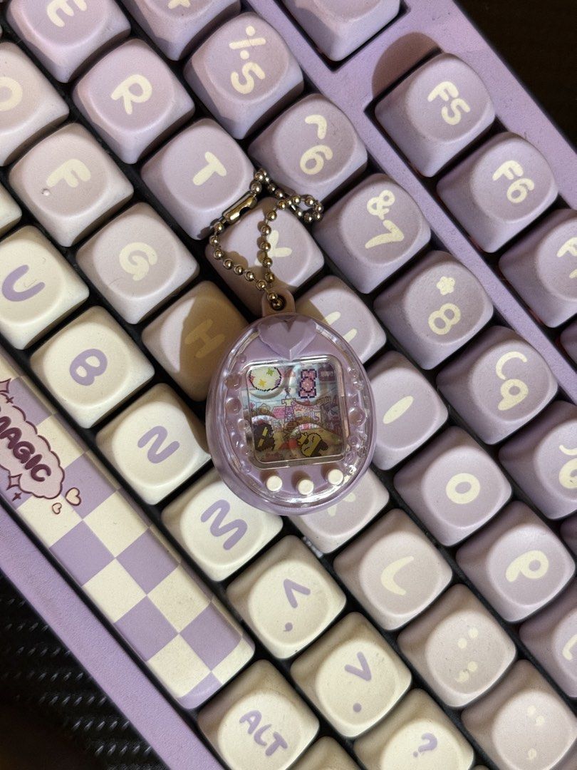 Tamagotchi Shaker Charms (Category: Designer & Blind Box Toys) located in Cabuyao City. Submitted by nethcantalejo8888 (Listing ID 1464567351, Image 2). Description: Tamagotchi Shaker Charm Purple Ps - Brand new, 1st and 2nd pic for reference only J&T shipping or SDD in nearby areas..