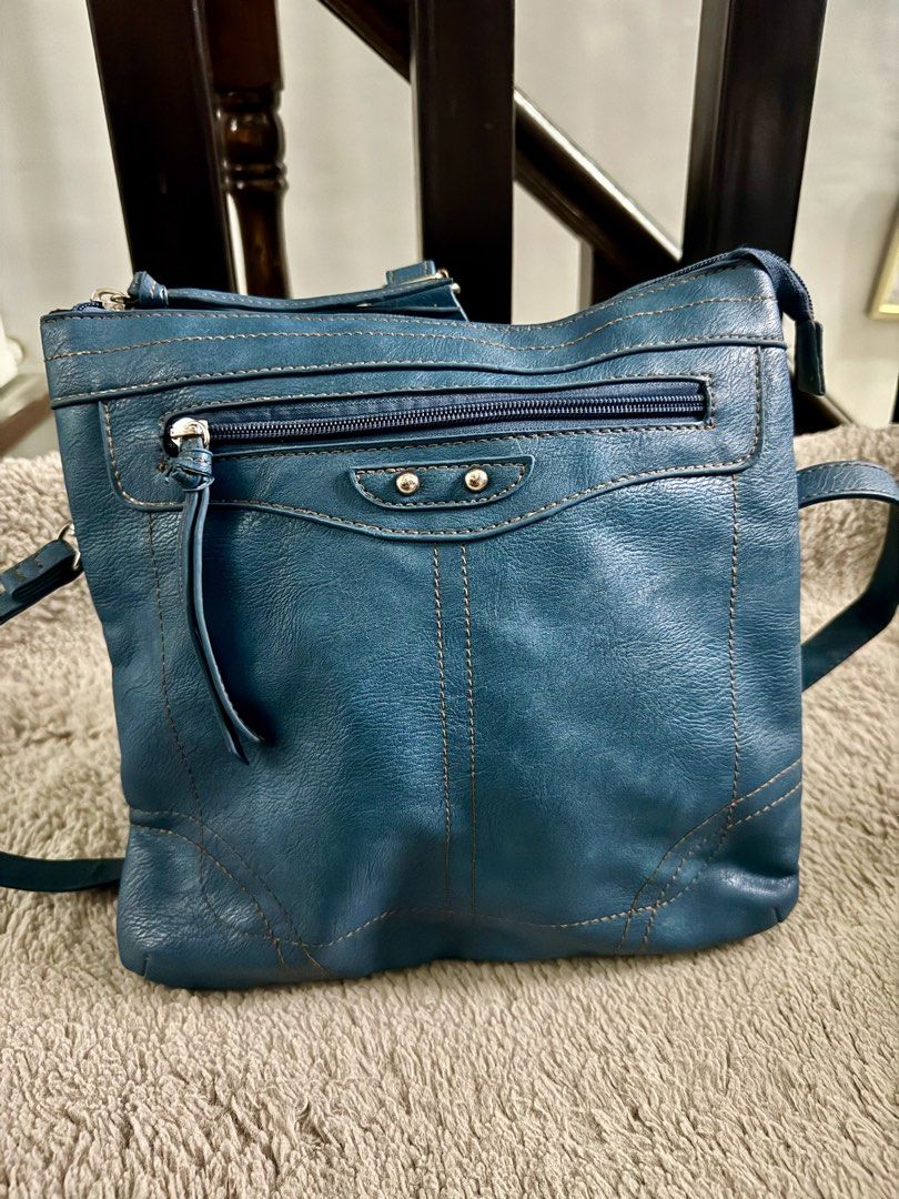Teal Leather Crossbody Bag with Multiple Compartments (Category: Cross-body Bags) located in Manila. Submitted by johfrancisco (Listing ID 1464423906, Image 1). Description: - Stylish blue-green leather crossbody bag - Main zippered compartment with internal dividers - Convenient front zippered pocket for quick access - Adjustable strap for comfortable wear - Ideal size for carrying everyday essentials - Attractive stitching detail all over.