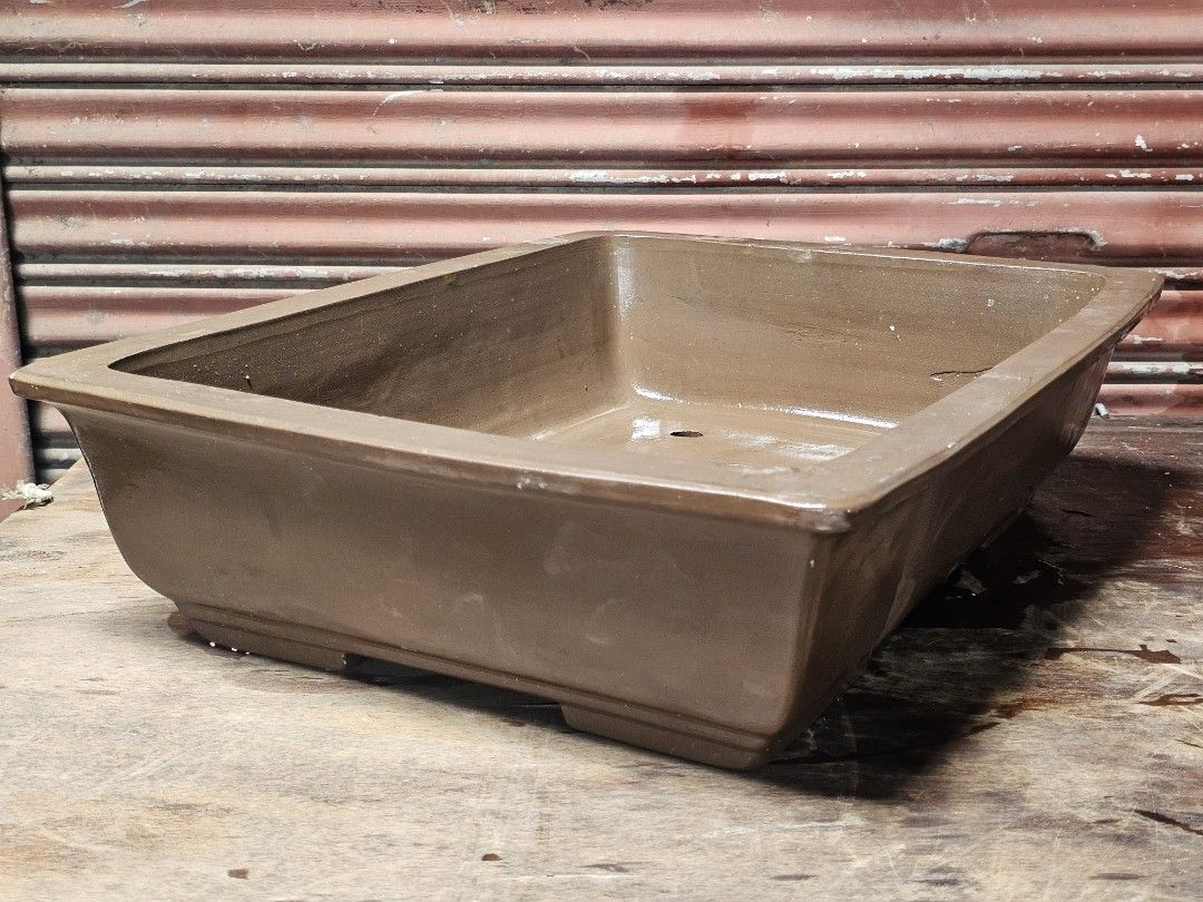 Teracotta Bonsai Pot Japan Imported (Category: Pots & Planters) located in Manila. Submitted by rarefindsph21 (Listing ID 1464569410, Image 1). Description: Large Rectangular Glazed Ceramic Bonsai Planter Pot Size: 21 × 16 × 6 inches Description: Large heavy-duty rectangular ceramic bonsai planter finished in an earthy brown glaze. Features a wide, deep planting area with multiple drainage and tie-down holes at the bottom, making it suitable for 