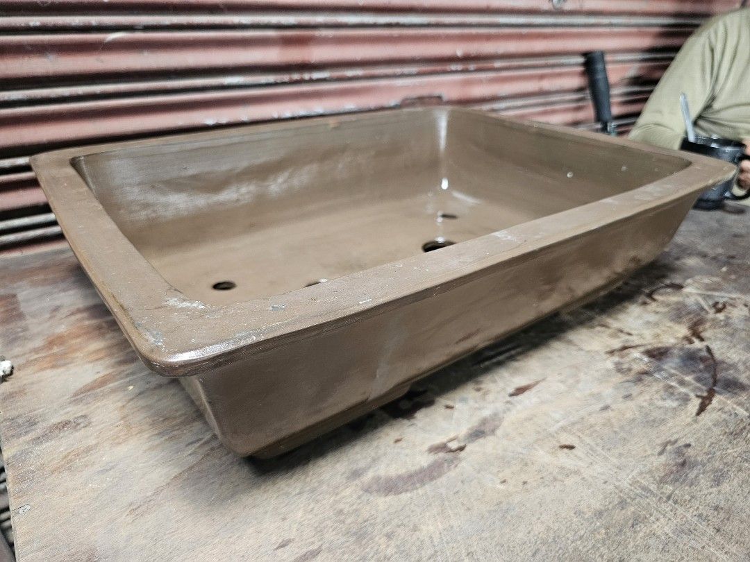Teracotta Bonsai Pot Japan Imported (Category: Pots & Planters) located in Manila. Submitted by rarefindsph21 (Listing ID 1464569410, Image 3). Description: Large Rectangular Glazed Ceramic Bonsai Planter Pot Size: 21 × 16 × 6 inches Description: Large heavy-duty rectangular ceramic bonsai planter finished in an earthy brown glaze. Features a wide, deep planting area with multiple drainage and tie-down holes at the bottom, making it suitable for 