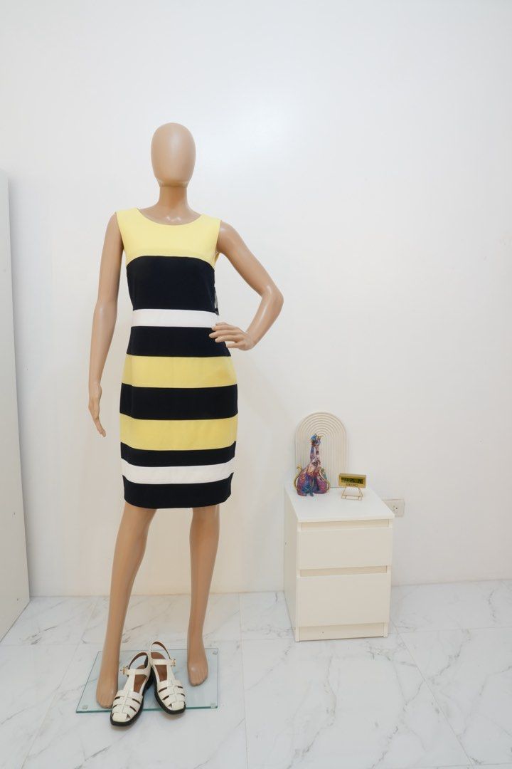 Tommy Hilfiger Dress (Category: Dresses) located in San Nicolas. Submitted by ihascat (Listing ID 1464436930, Image 2). Description: - Sleeveless dress - Horizontal stripes - Color blocking: Yellow, black, and white - Knee-length cut - Comfortable fit - Versatile for casual outings or office wear - Pairs well with heels or flats.