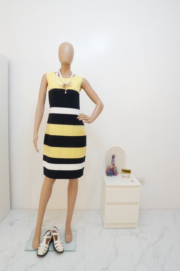 Tommy Hilfiger Dress (Category: Dresses) located in San Nicolas. Submitted by ihascat (Listing ID 1464436930, Image 1). Description: - Sleeveless dress - Horizontal stripes - Color blocking: Yellow, black, and white - Knee-length cut - Comfortable fit - Versatile for casual outings or office wear - Pairs well with heels or flats.