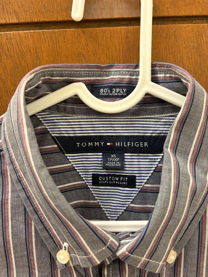 Tommy Hilfiger Gray Multi-Stripe Long Sleeve Button-Down Shirt (Category: Tshirts & Polo Shirts ) located in Mandaluyong City. Submitted by jbor88 (Listing ID 1464367429, Image 2). Description: Classic Tommy Hilfiger button-up shirt Blue and white vertical stripes with subtle red pinstripes Button-down collar Long sleeves with button cuffs Small embroidered logo on chest pocket Custom Fit XS W=50cm L=74cm.
