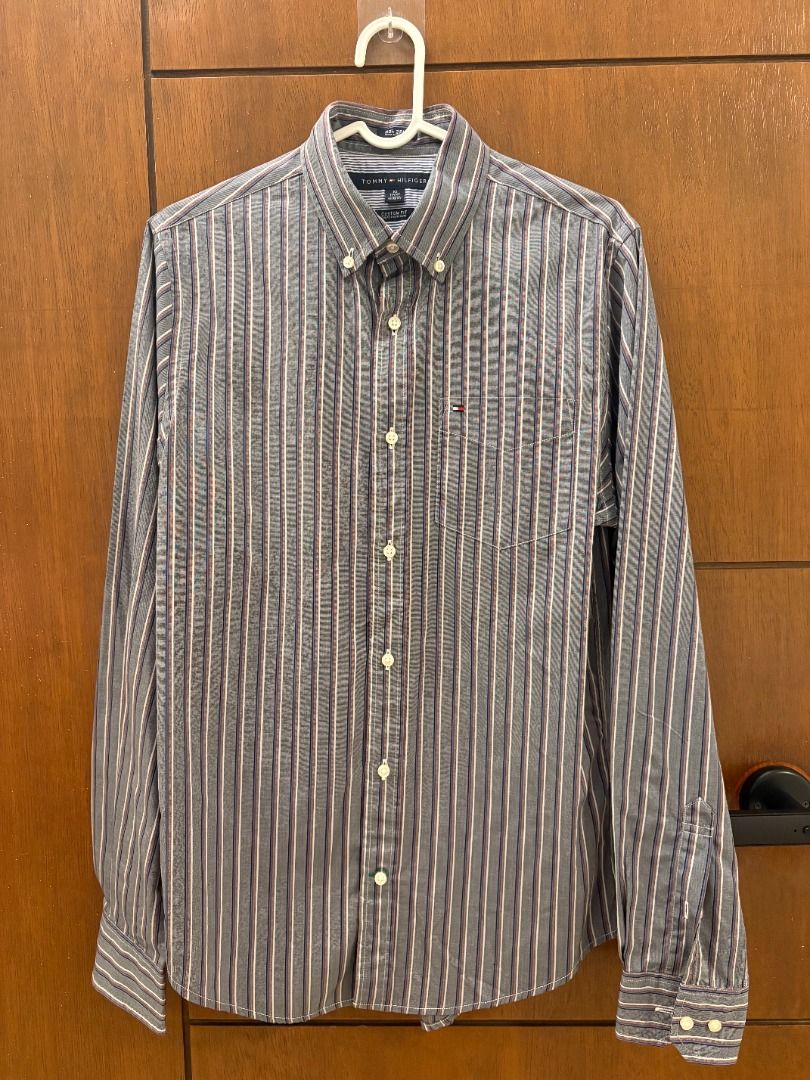 Tommy Hilfiger Gray Multi-Stripe Long Sleeve Button-Down Shirt (Category: Tshirts & Polo Shirts ) located in Mandaluyong City. Submitted by jbor88 (Listing ID 1464367429, Image 1). Description: Classic Tommy Hilfiger button-up shirt Blue and white vertical stripes with subtle red pinstripes Button-down collar Long sleeves with button cuffs Small embroidered logo on chest pocket Custom Fit XS W=50cm L=74cm.