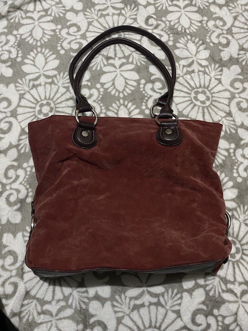 Tommy Hilfiger Red Suede Tote Bag (Category: Tote Bags) located in Manila. Submitted by mysticcat15 (Listing ID 1464502135, Image 1). Description: mop: gcash/bank transfer mod: jnt - Brand: Tommy Hilfiger - Material: Red suede with dark brown leather handles and trim - Hardware: Silver details on the sides - Interior: Maroon lining - Features: Plenty of space, great for everyday use flaws on the pic.