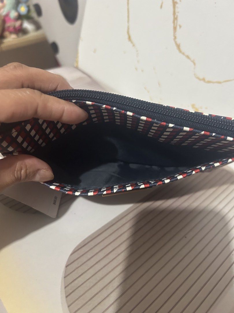 Tommy Hilfiger Wristlet Pouch Red White Blue Geometric Pattern (Category: Purses & Pouches) located in Manila. Submitted by trendsby_t (Listing ID 1464539176, Image 3). Description: - Authentic Tommy Hilfiger wristlet pouch - Stylish geometric pattern in red, white, and blue - Convenient wrist strap for easy carrying - Secure zip closure - Classic navy blue interior - Brand new with original tag attached - Ideal for keeping your essentials organi