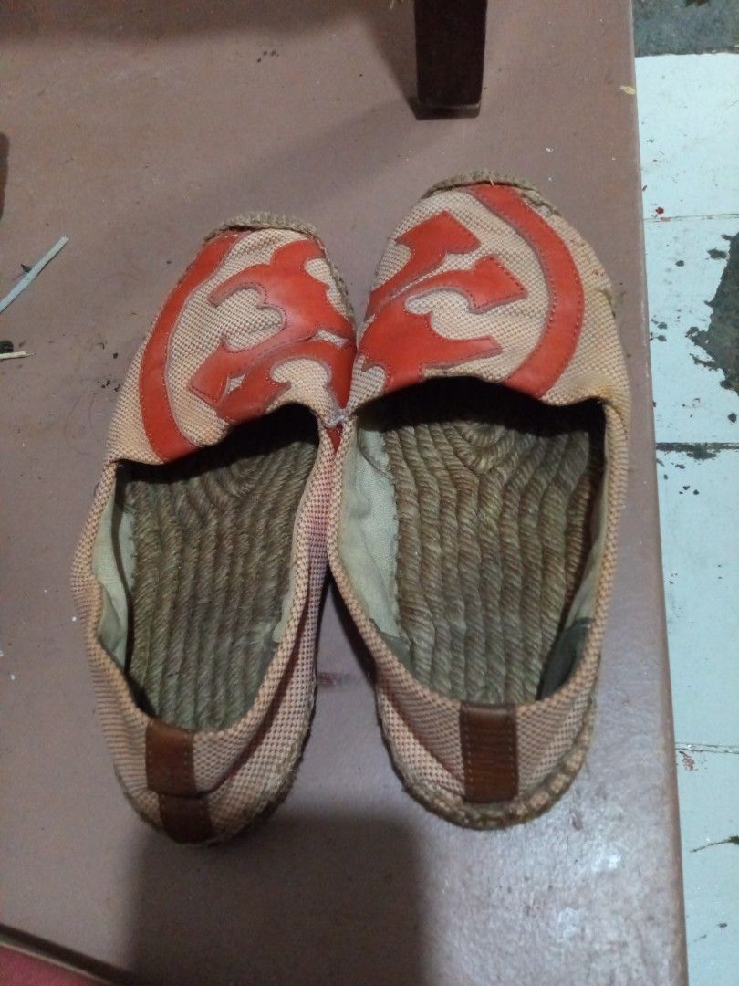 Tory Burch Espadrilles Orange & Beige (Category: Flats & Sandals) located in Pasig City. Submitted by zakquinnjax44 (Listing ID 1464567163, Image 1). Description: - Tory Burch espadrilles in orange and beige. - Features the signature Tory Burch logo on the sole. - Stylish rope detailing around the sole. - Shows some signs of wear on the soles, adding character. - Ideal for comfortable and chic casual wear..