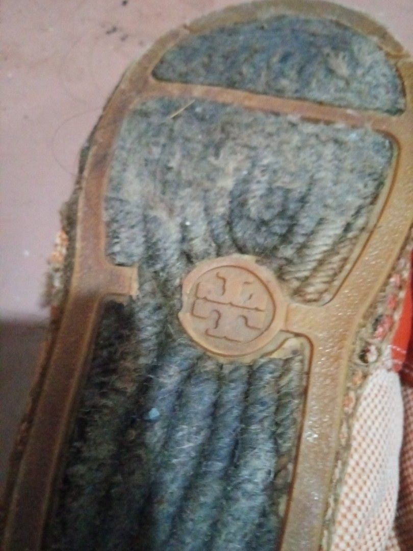 Tory Burch Espadrilles Orange & Beige (Category: Flats & Sandals) located in Pasig City. Submitted by zakquinnjax44 (Listing ID 1464567163, Image 3). Description: - Tory Burch espadrilles in orange and beige. - Features the signature Tory Burch logo on the sole. - Stylish rope detailing around the sole. - Shows some signs of wear on the soles, adding character. - Ideal for comfortable and chic casual wear..