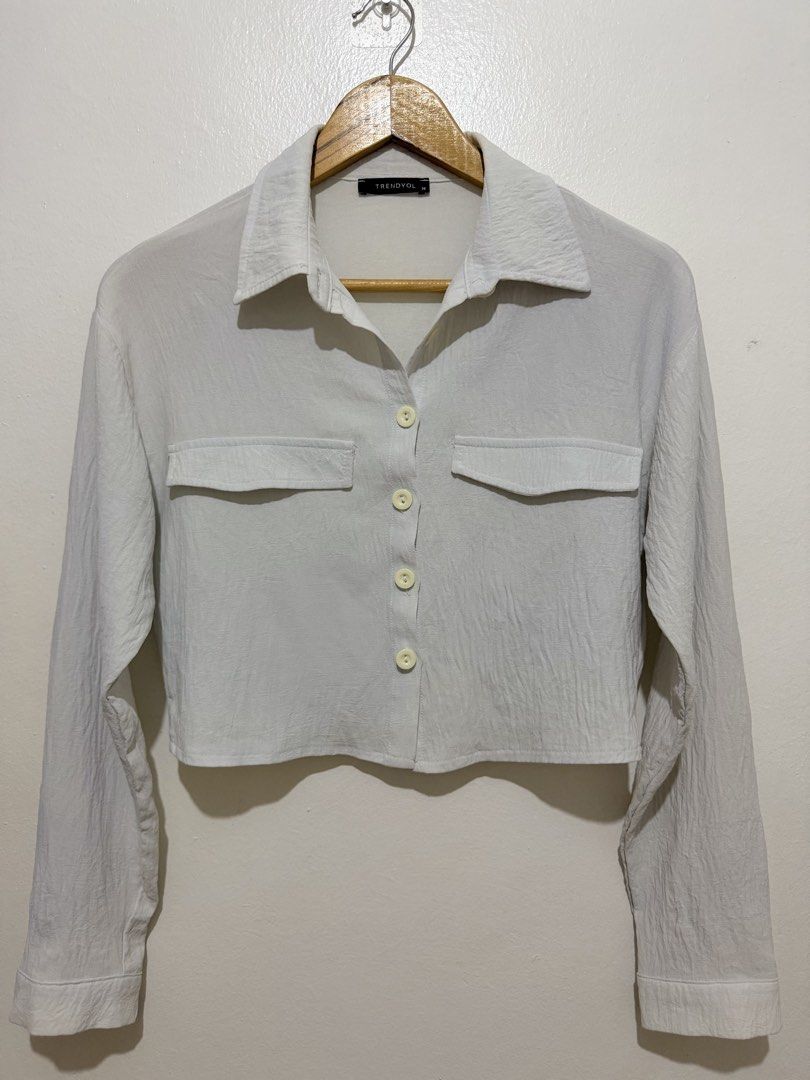 Light Blue Textured Flowy Polo Croptop (Category: Shirts) located in Caloocan City. Submitted by ashpreloves (Listing ID 1464383014, Image 1). Description: - Long sleeves with button cuffs - Two chest pockets with button closures - Collared neckline - Textured fabric - Versatile: pairs well with high-waisted bottoms.