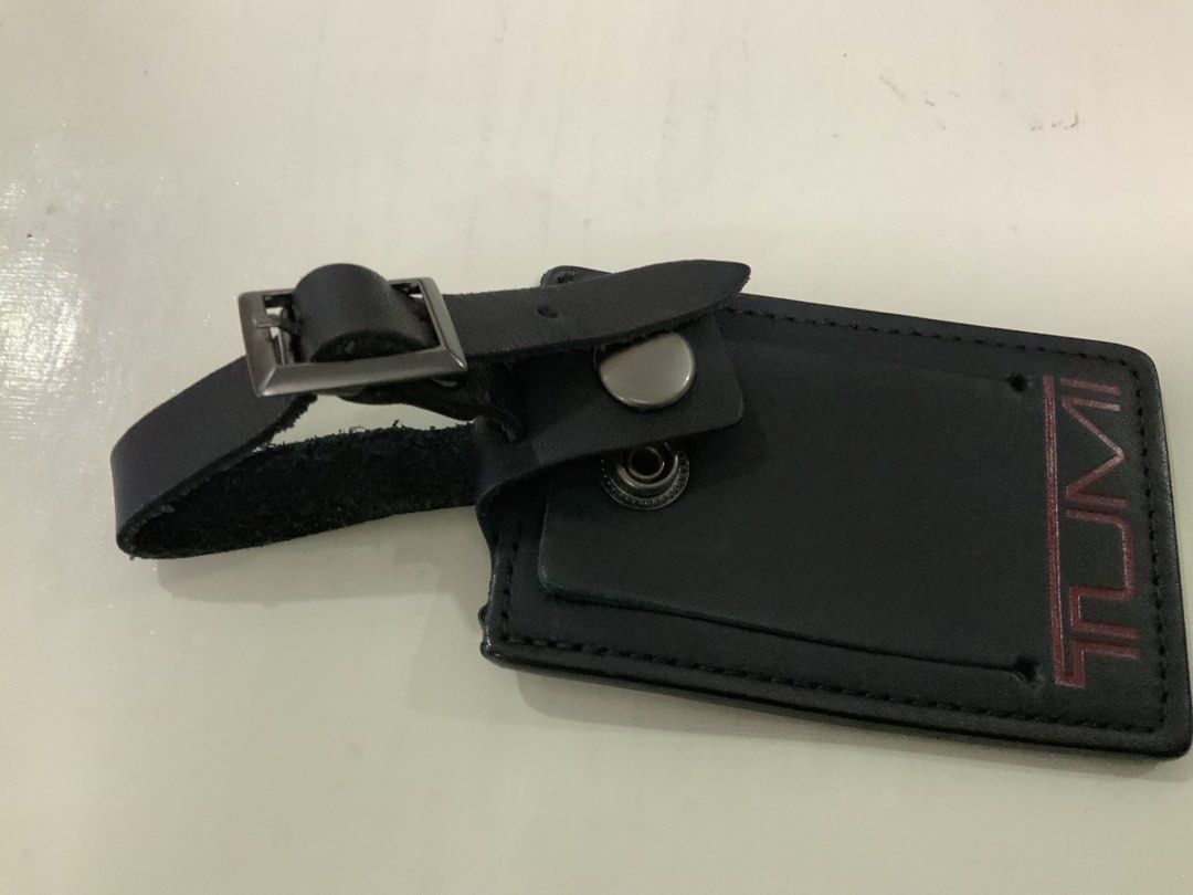Tumi Black Leather Luggage Tag with Strap (Category: Luggage) located in San Fernando. Submitted by destinydeals04 (Listing ID 1464568152, Image 3). Description: - original genuine Tumi luggage tag - Made of black leather - Features embossed Tumi logo - Adjustable strap with buckle for secure attachment - Ideal for travel Excellent condition and how many time only used.