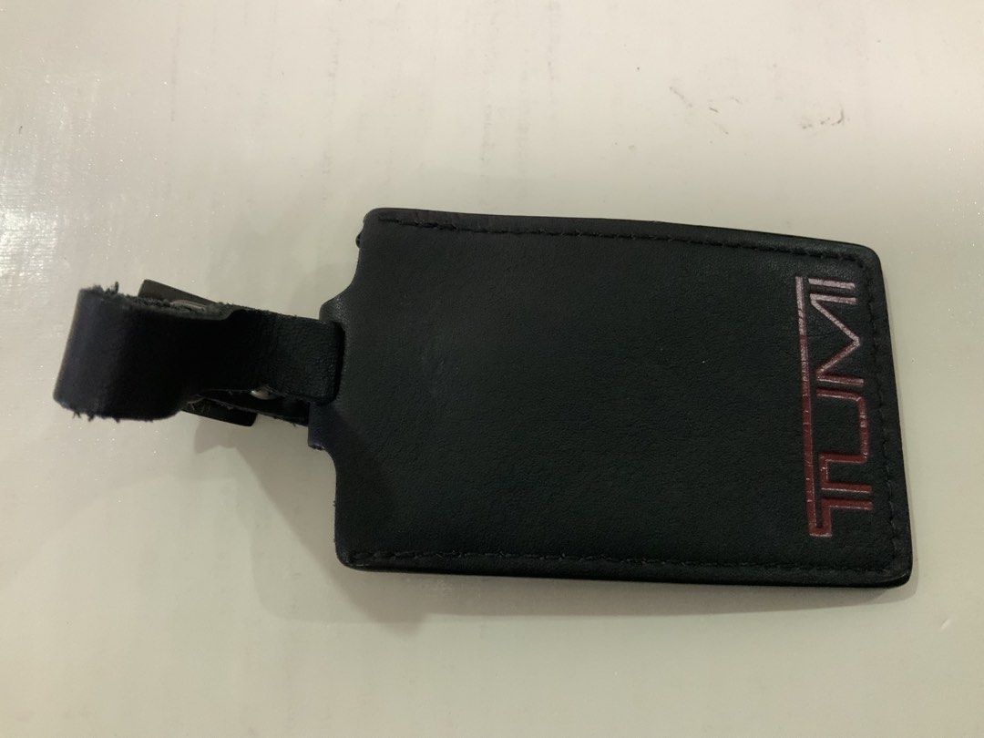 Tumi Black Leather Luggage Tag with Strap (Category: Luggage) located in San Fernando. Submitted by destinydeals04 (Listing ID 1464568152, Image 2). Description: - original genuine Tumi luggage tag - Made of black leather - Features embossed Tumi logo - Adjustable strap with buckle for secure attachment - Ideal for travel Excellent condition and how many time only used.