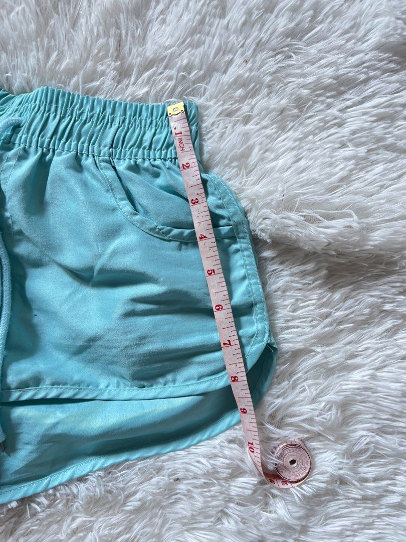 Turquoise Athletic Shorts with Drawstring Waist (Category: Shorts) located in Valenzuela. Submitted by lovepatt (Listing ID 1464439469, Image 3). Description: - Vibrant turquoise athletic shorts - Comfortable elastic waistband with adjustable drawstring - Two convenient front pockets - Stylish dolphin hem for a flattering look - Lightweight and breathable material, ideal for workouts or lounging.