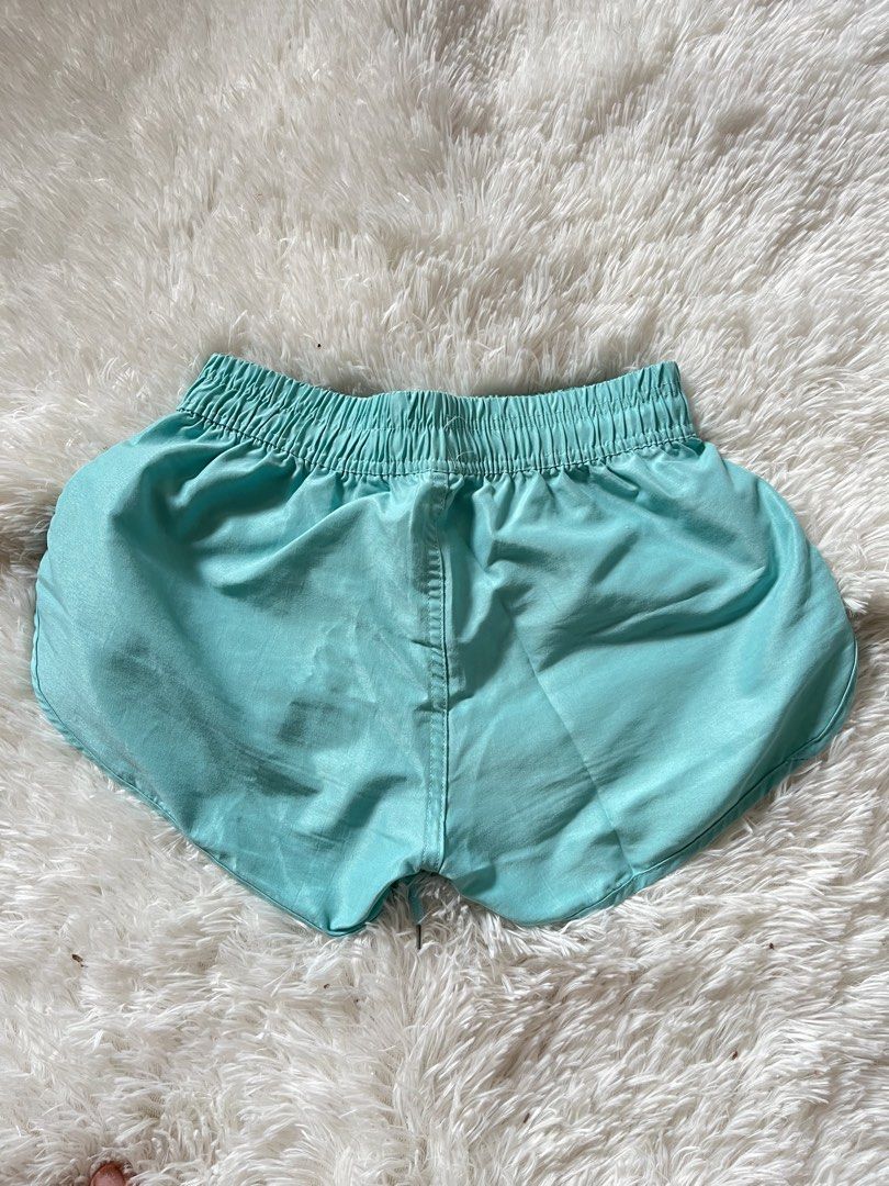 Turquoise Athletic Shorts with Drawstring Waist (Category: Shorts) located in Valenzuela. Submitted by lovepatt (Listing ID 1464439469, Image 2). Description: - Vibrant turquoise athletic shorts - Comfortable elastic waistband with adjustable drawstring - Two convenient front pockets - Stylish dolphin hem for a flattering look - Lightweight and breathable material, ideal for workouts or lounging.