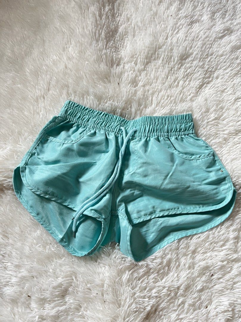 Turquoise Athletic Shorts with Drawstring Waist (Category: Shorts) located in Valenzuela. Submitted by lovepatt (Listing ID 1464439469, Image 1). Description: - Vibrant turquoise athletic shorts - Comfortable elastic waistband with adjustable drawstring - Two convenient front pockets - Stylish dolphin hem for a flattering look - Lightweight and breathable material, ideal for workouts or lounging.