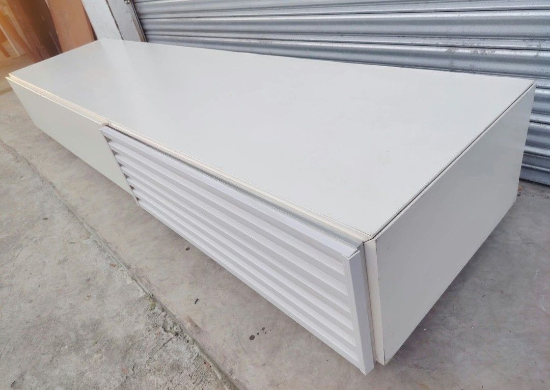 TV Rack low type (Category: TV Consoles) located in Taguig. Submitted by sydney08.owl (Listing ID 1464531268, Image 2). Description: item: LONG TV RACK (Low type) Size: L-76 W-19 H-11 inches Price: ₱9500+ delivery fee Description: -Made of wood and plyboard -2 cabinet door equipped w/ PNEUMATIC lift support mechanism for easy opening -Minimal scratches.