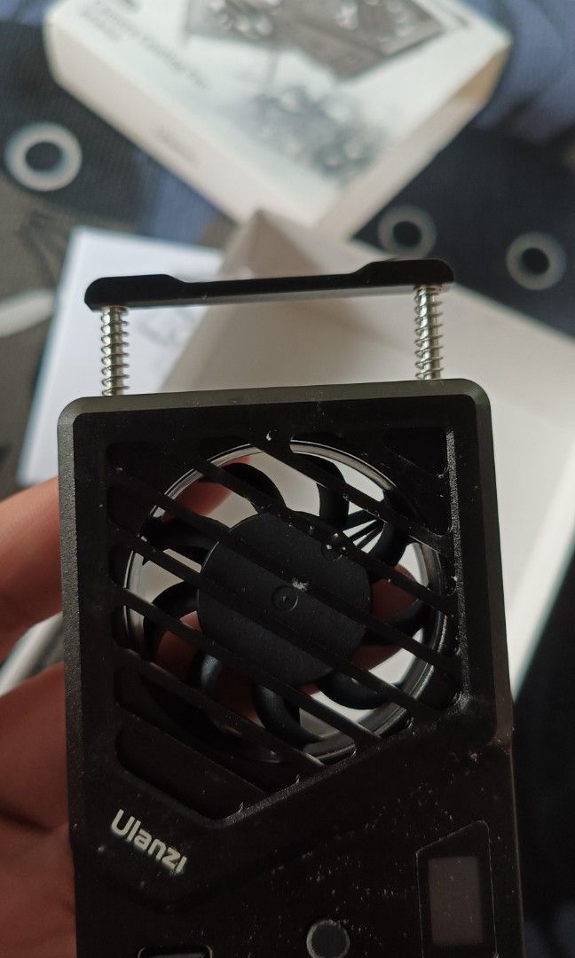 Ulanzi CA25 Camera Cooling Fan (Category: Fans) located in Manila. Submitted by cgbcollection (Listing ID 1464446970, Image 2). Description: - Ulanzi CA25 Camera Cooling Fan - Prevents camera overheating during long shoots - Includes USB cable - Comes with original packaging - Easy to attach and use - Ideal for vlogging and extended filming sessions.