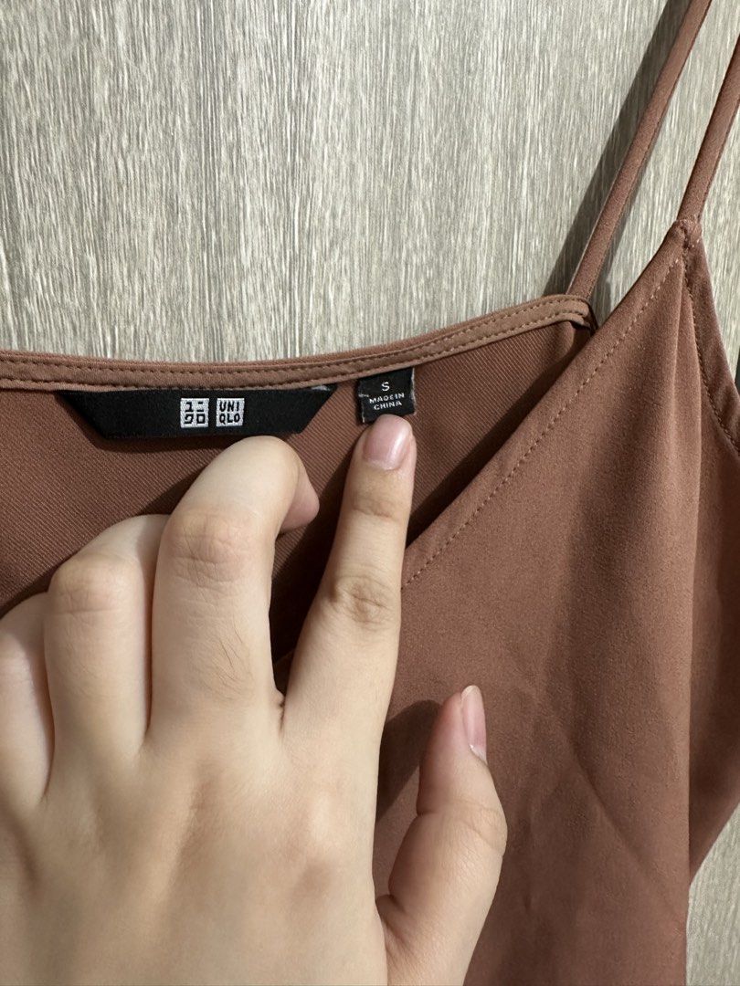 Uniqlo Brown Cami Top Size S (Category: Sleeveless) located in Manila. Submitted by micsevang59553 (Listing ID 1464468070, Image 2). Description: - Uniqlo brown cami top - Features spaghetti straps - V-neckline design - Versatile for layering or wearing on its own - Easy to pair with various outfits.