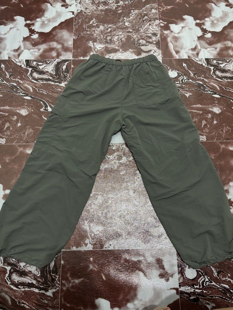 Uniqlo Cargo Pants Olive Green (Category: Jeans) located in Caloocan City. Submitted by clang17. (Listing ID 1464384770, Image 2). Description: - Uniqlo Olive Green Cargo Pants - Elastic waistband with drawstring - Wide leg fit - Adjustable toggles at the hem - Two side pockets and one right leg cargo pocket - Made from recycled nylon - Ideal for casual wear or outdoor activities.