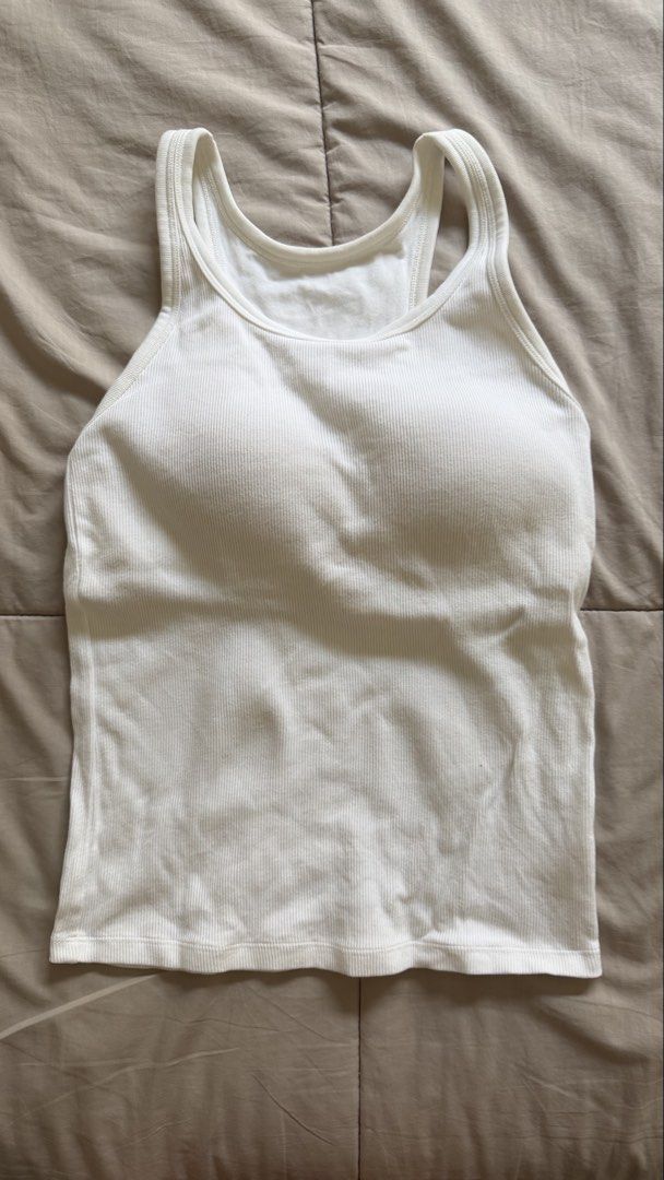 Uniqlo Ribbed Bra Top (Category: Sleeveless) located in Makati City. Submitted by nisayaptinchay (Listing ID 1464365136, Image 1). Description: - Basic white ribbed tank top - Racerback style - Minor orange marks on the back (please check photos for details) - Perfect for layering or casual outfits.